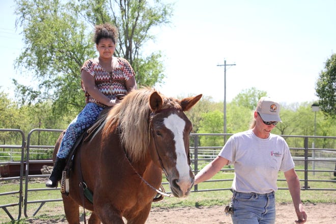 Ten-year-old Leah Smith rides a horse for the first time at B&C Equine Rescue’s Help a Horse Day in Carbondale. (Katie Moore/The Capital-Journal)