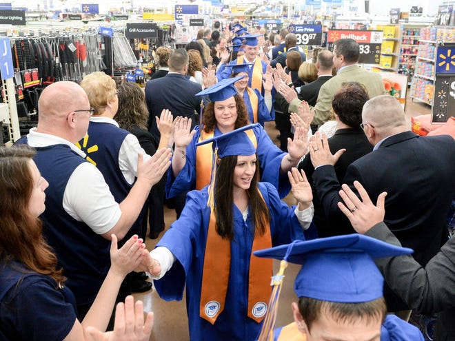 Wal-Mart managers high-five and congratulate graduates of the new Wal-Mart Training Academy in Canton. (GateHouse Ohio Media / Michael Balash)
