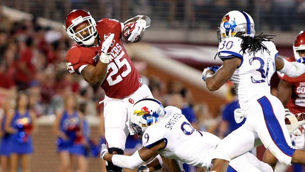 Oklahoma running back Joe Mixon, facing Kansas last year, made one of his pre-draft visits to the Jaguars earlier this month. Suspended for assaulting a woman in 2014, Mixon is one of the most polarizing propects in the NFL Draft. (Associated Press)