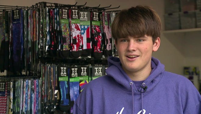 This April 22, 2017 frame from video provided by KATU-TV shows Brendan Agranoff, 17, in his sock factory and warehouse at his home in Sherwood, Ore. Agranoff spends his days going to high school, doing chores and running his custom-design sock business. Television station KATU reports that it's no simple hobby: Agranoff is the founder and CEO of HoopSwagg, and he's already sold $1 million in custom socks. THE ASSOCIATED PRESS