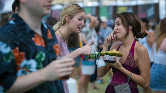 SunFest snacking: Locals share a Pineapple Chicken dish at last year's fest. Allen Eyestone / The Palm Beach Post