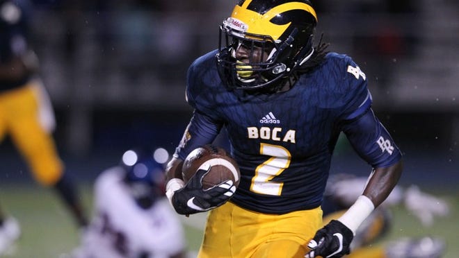 Shelley Singletary, 18, begins spring football practice this week for Boca Raton High School in Palm Beach County while wearing an ankle monitor because he is facing a felony charge in connection with the strong-arm robbery of an 11-year-old in January. Singletary is seen here running for a large gain during a game on Sept. 30, 2016. (Richard Graulich / The Palm Beach Post)