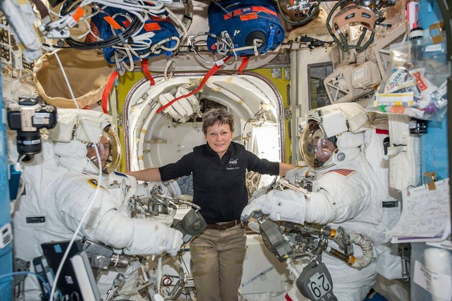 In this Jan. 13, 2017 file photo made available by NASA, astronaut Peggy Whitson, center, floats inside the Quest airlock of the International Space Station with Thomas Pesquet, left, and Shane Kimbrough before their spacewalk. Early Monday, April 24, 2017, the International Space Station commander surpassed the 534-day, two-hour-and-48-minute record set last year by Jeffrey Williams for most accumulated time in orbit by an American. Whitson already was the world’s most experienced spacewoman and female spacewalker and, at age 57, the oldest woman ever in space. (NASA via AP, File)