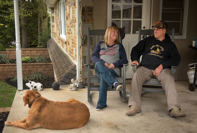Local contractors recently renovated the home of home of Kathy and Jack MacIntosh, seen here on the porch with their dog, Puxi, Tuesday, April 25, 2017, in the Feasterville section of Lower Southampton. A ribbon-cutting ceremony was held at the house earlier the same day.