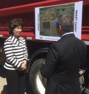 U.S. Transportation Secretary Elaine Chao, left, speaks with Transportation Research Center President and CEO Mark-Tami Hotta during a tour of the center in East Liberty. [Dan Gearino/Dispatch]
