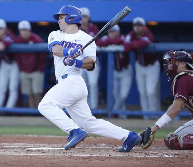 Florida catcher Mark Kolozsvary hits on March 14 against Florida State at McKethan Stadium in Gainesville. [GATEHOUSE MEDIA GROUP FILE]