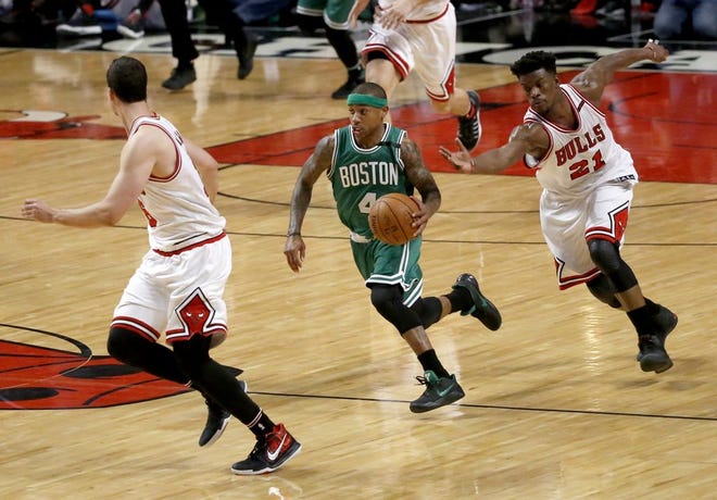 Boston Celtics' Isaiah Thomas (4) leads the fast break past Chicago Bulls' Jimmy Butler (21) and toward Paul Zipser during the second half in Game 4 of an NBA basketball first-round playoff series in Chicago, Sunday, April 23, 2017.