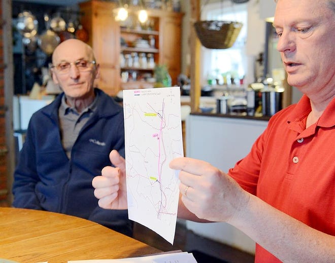 Town of Herkimer resident Tim Farrell, right, shows a map of the affected area along state Route 28 between Oberle Road and Schrader Hill Road that does not have internet through Time Warner Cable on April 17 in the Town of Herkimer. Also pictured is Burt Helmer. [ALEX COOPER/OBSERVER-DISPATCH]