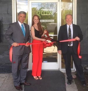 Mayor Bill Saffo, left, and Wilmington Downtown Inc. President Ed Wolverton, right, cut the ribbon for Grow, a new co-working space downtown with, co-owner Adrienne Vendetti.

[CONTRIBUTED PHOTO]