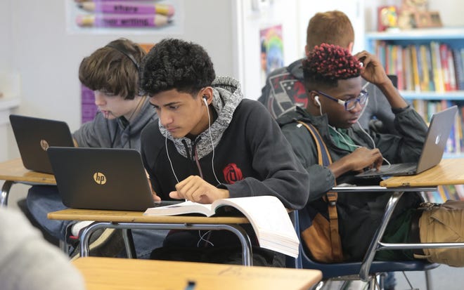 Hayden Hammond, from left, Carlos Andriano and Kentarious McNeil work with their Chromebooks in the Grade Acceleration Program at Jinks Middle School in January. Students and teachers at two more schools will receive Chromebooks in August. [HEATHER HOWARD/NEWS HERALD FILE PHOTO]