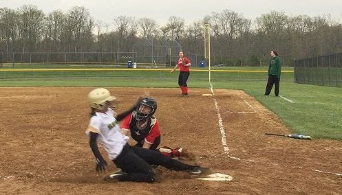 Seneca's Krysten Emenecker is out at home plate as catcher Madi Palat of Cherry Hill East applies a tag during Wednesday's Olympic Conference game. Seneca defeated the Cougars, 10-0.