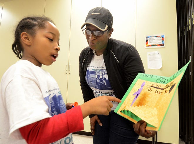 (file) The Volunteer Center of Burlington County is honoring three people with awards this year. Pictured above, Chyanne Edwin, 8, a student at Twin Hills Elementary School in Willingboro, explains the get well card she created Monday, Jan. 18, 2016, to Cathy Jones-Alalouf, a Twin Hills special education teacher, at the Volunteer Center of Burlington County's 10th annual MLK Day of Challenge held at the Burlington County Library in Westampton.