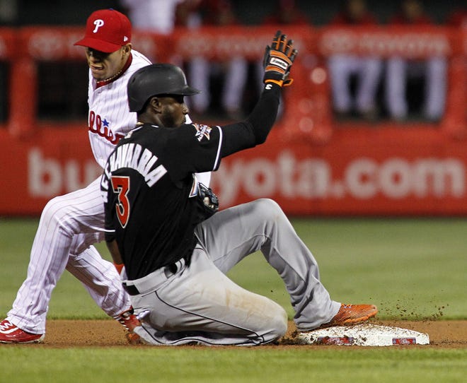 Marlins baserunner Adeiny Hechavarria gets back to second safely as Phillies second baseman Maikel Franco is late with the tag during the seventh inning Wednesday, April 26, 2017, in Philadelphia.