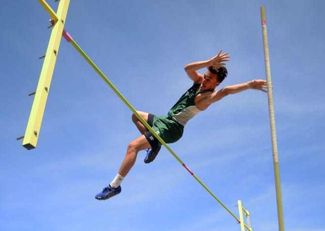 Riverside's Dylan Griffith pushes the pole away as he clears the bar in the pole vault at the MAC track championships Wednesday at Mars High School.