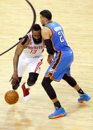 James Harden (left) collides with the Thunder's Andre Roberson during the NBA playoffs last season. (Photo by Sarah Phipps)