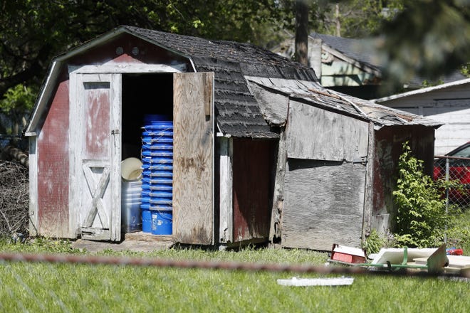 A shed stands in a backyard where police say a man with mental health problems kidnapped a neighbor and kept her trapped in a small grave-like pit in the shed Wednesday, April 26, 2017, in Blanchester. Ohio. Police in Blanchester, about 40 miles northeast of Cincinnati, said the owner of the shed, Dennis Dunn, was arrested on Wednesday and was taken to a hospital. THE ASSOCIATED PRESS