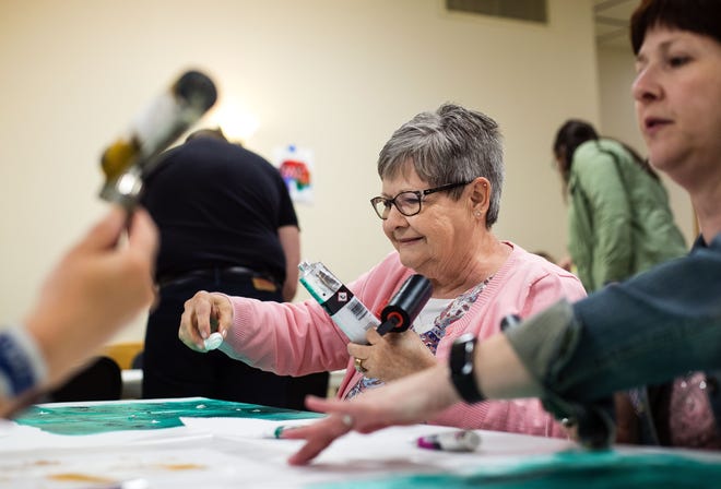 Ruth Taapken works on her first touchpaint creation during the "Canvas with a Cause" fundraiser for Hazel Dell Elementary School Wednesday, April 26, 2017. The fundraiser was a class project of the UIS graduate students in the Human Development Counseling class. [Ted Schurter/The State Journal-Register]