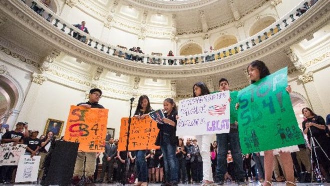 Wendy Membreno, 9, center, addresses those gathered in the Texas State Capitol Rotunda to voice their opposition to SB 4 Wednesday night as the Texas House prepared to vote on the bill that would outlaw “sanctuary” jurisdictions in the state. TOM MCCARTHY JR. FOR AMERICAN-STATESMAN
