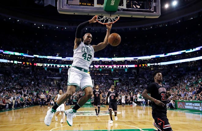 Boston Celtics center Al Horford slams a dunk against the Chicago Bulls during the fourth quarter of a first-round NBA playoff basketball game in Boston, Wednesday, April 26, 2017. The Celtics defeated the Bulls 108-97.