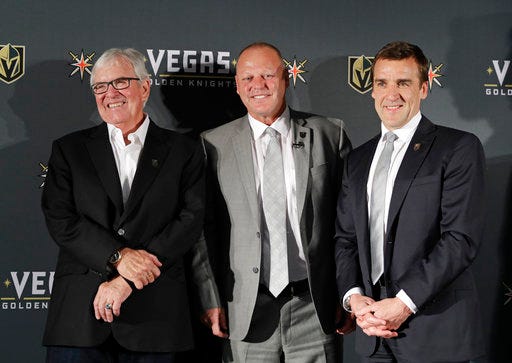 FILE - In this April 13, 2017, file photo, Vegas Golden Knights coach Gerard Gallant is flanked by Bill Foley, left, owner of the Vegas Golden Knights, and George McPhee, Vegas Golden Knights general manager, in Las Vegas. Vegas Golden Knights general manager George McPhee certainly wouldn't mind some Lady Luck to rub off on his NHL expansion franchise when it comes to how the balls drop in the league's draft lottery on Saturday. (AP Photo/John Locher, File)