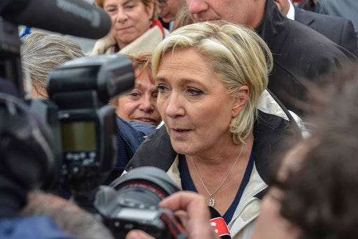 French far-right leader and candidate for the presidential election Marine le Pen answers reporters after a sea trip in Grau-du-Roi, southern France, Thursday April 27, 2017. After "the battle of Whirlpool," when Marine Le Pen and centrist candidate Emmanuel Macron both went hunting for France's blue-collar vote, the presidential candidates clashed over fish in a return to more traditional campaigning. (AP Photo/Jean-Paul Bonincontro)