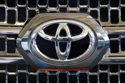 FILE - This Thursday, Feb. 11, 2016, file photo shows the Toyota logo on the grill of a 2016 Toyota Tacoma on display at the Pittsburgh International Auto Show, in Pittsburgh. Toyota is recalling about 250,000 small pickup trucks mainly in North America because the rear wheels have the potential to lock up, causing drivers to lose control. The recall covers certain Tacoma trucks from 2016 and 2017. (AP Photo/Gene J. Puskar, File)