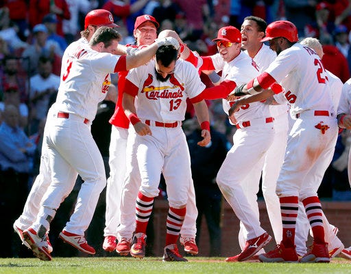 St. Louis Cardinals' Matt Carpenter (13) is congratulated by teammates after hitting a walk-off grand slam to defeat the Toronto Blue Jays 8-4 in 11 innings in the first baseball game of a doubleheader Thursday, April 27, 2017, in St. Louis. (AP Photo/Jeff Roberson)