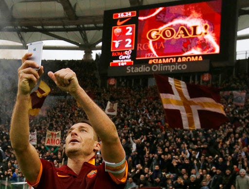 FILE - In this Sunday, Jan. 11, 2015 file photo, Roma's Francesco Totti celebrates with a selfie after scoring during a Serie A soccer match between Roma and Lazio at Rome's Olympic stadium. Roma great Francesco Totti wants "to destroy" Lazio in what could be his last ever derby on Sunday. (AP Photo/Gregorio Borgia, File)