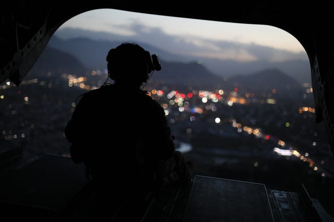 A U.S. Army helicopter crewman mans a gun on the rear gate as it departs Resolute Support headquarters with U.S. Defense Secretary James Mattis aboard in Kabul, Afghanistan, Monday, April 24, 2017. THE ASSOCIATED PRESS