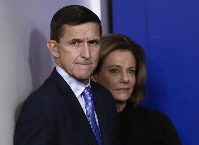 In this Feb. 1, 2017 file photo, then-National Security Adviser Michael Flynn, joined by K.T. McFarland, deputy national security adviser, watches the daily news briefing at the White House in Washington. Documents released by lawmakers show Flynn, now former national security adviser, was warned when he retired from the military in 2014 not to take foreign money without "advance approval" by Pentagon authorities. THE ASSOCIATED PRESS