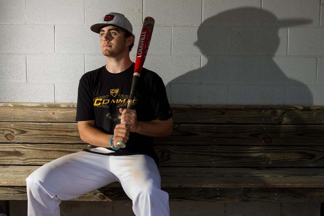 Davis Balentine poses for a photo in the dugout at New Bern High School on Thursday afternoon. [Todd F. Michalek / Sun Journal Staff]