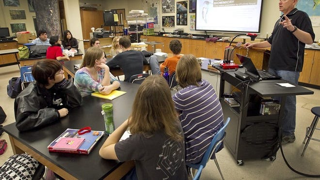 These Liberal Arts and Science Academy high school students at LBJ participate in an Advanced Placement Environmental Science class taught by teacher Tim Fennell, right. (RALPH BARRERA/AMERICAN-STATESMAN 2011)