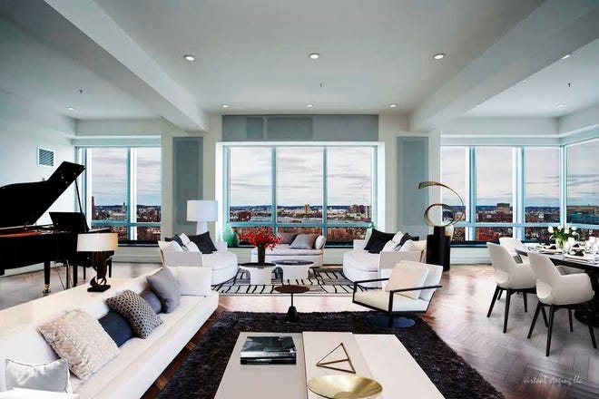 A stunning three-bedroom corner unit at the Residences at the Ritz-Carlton boasts an expanse of windows, a gourmet kitchen, a family room, four marble bathrooms and this fabulous living room. It is listed at $5,195,000.