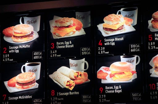 FILE - In this Sept. 12, 2012 file photo, items on the breakfast menu, including the calories, are posted at a McDonald's restaurant in New York. Facing a May 5, 2017 compliance deadline set by the Food and Drug Administration last year, some restaurants and other establishments are eyeing a massive spending bill that Congress will have to pass in the next week to keep the government open and hope to either delay the menu labeling rules again or include legislation in the larger bill that would revise the law and make it easier for some businesses to comply. (AP Photo/Mark Lennihan, File)