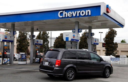 In this Tuesday, April 25, 2017, photo, a motorist drives near the pumps at a Chevron gas station, in Oakland, Calif. Chevron Corp. reports earnings on Friday, April 28, 2017. (AP Photo/Ben Margot)