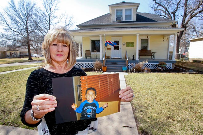 Judy Conway holds a photo of her grandson Adrian Jones, who was killed in 2015. His father and stepmother, who home-schooled Jones, were charged with his murder. (Chris Neal/The Capital-Journal)