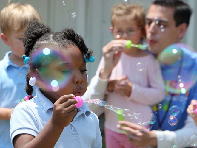 Kamira King, 4, and her classmates participate in the “Blowing Bubbles 4 Autism” event Friday at Cedar Grove Elementary School. [ANDREW WARDLOW/THE NEWS HERALD]