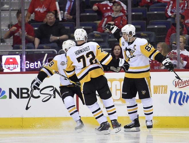 Pittsburgh Penguins center Sidney Crosby (87) celebrates his goal with Patric Hornqvist (72) and Jake Guentzel (59) during the second period of Game 1 of an NHL hockey Stanley Cup second-round playoff series against the Washington Capitals on Thursday in Washington. [AP Photo / Nick Wass]