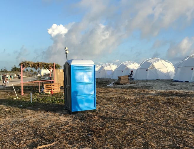 This photo provided by Jake Strang shows tents and a portable toilet set up for attendees for the Fyre Festival, Friday, April 28, 2017 in the Exuma islands, Bahamas. Organizers of the much-hyped music festival in the Bahamas canceled the weekend event at the last minute Friday after many people had already arrived and spent thousands of dollars on tickets and travel. A statement cited "circumstances out of our control," for their inability to prepare the "physical infrastructure" for the event in the largely undeveloped Exumas. (Jake Strang via AP)