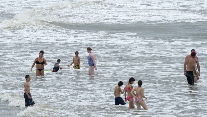 People wade in the water of the Atlantic Ocean, off St. Augustine Beach, on June 7. (Florida Times-Union, file)