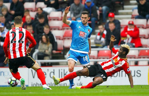 AFC Bournemouth's Lewis Cook, center, and Sunderland's Didier Ibrahim Ndong battle for the ball during the English Premier League soccer match at the Stadium of Light, Sunderland, England, Saturday, April 29, 2017. (Richard Sellers/PA via AP)