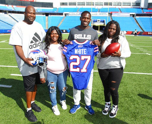 Buffalo Bills; first-round NFL football draft pick Tre'Davious White, second from right, poses with, from left to right, his father, David White, mother, LaShawnita Ruffins, and sister, La'Daijah White, following a media conference at New Era Field in Orchard Park, N.Y., Friday, April 28, 2017. (AP Photo/Bill Wippert)