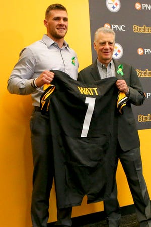 Pittsburgh Steelers first-round pick in the NFL football draft, T.J. Watt, left, poses with Steelers President Art Rooney II and a jersey during his introductory news conference, Friday, April 28, 2017, in Pittsburgh. (AP Photo/Keith Srakocic)