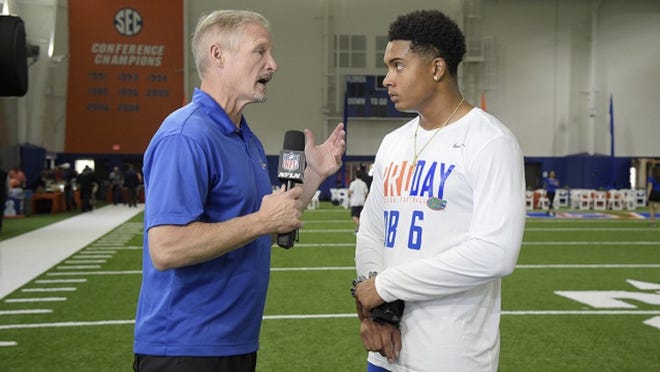 NFL Network analyst Mike Mayock, left, talks with defensive back Quincy Wilson (6) during Florida's NFL Pro Day in Gainesville, Fla., Tuesday, March 28, 2017. (AP Photo/Phelan M. Ebenhack)