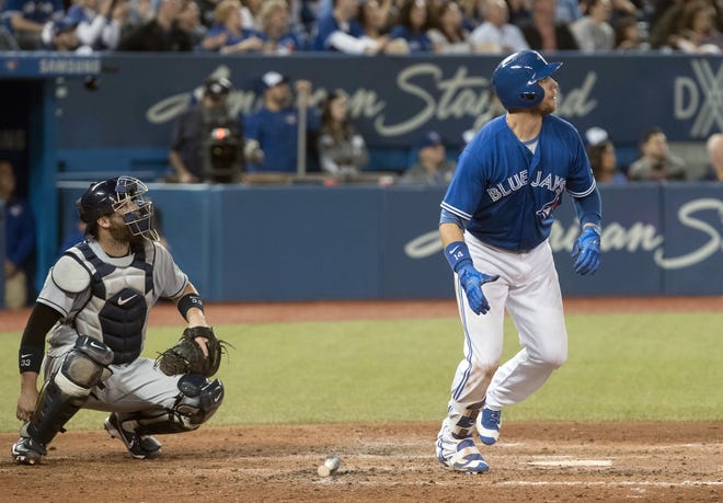 The Toronto Blue Jays' Justin Smoak hits a 2-run home run against the Tampa Bay Rays in the sixth inning in Toronto on Saturday. [FRED THORNHILL / THE CANADIAN PRESS VIA AP]