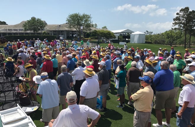 Volunteers stand near the first hole at Eagle Point Golf Club Saturday to go through training for the upcoming Wells Fargo Championship. [Jackson Fuller/StarNews]