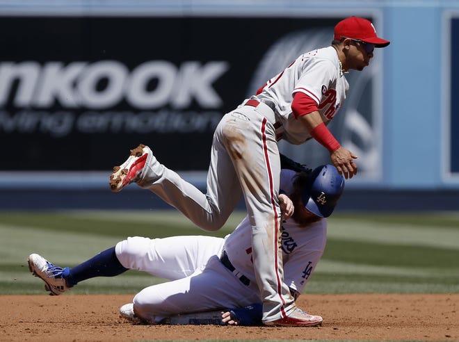 Phillies second baseman Cesar Hernandez makes the tag to get Justin Turner out at second base during the first inning in Los Angeles on Sunday, April 30, 2017.