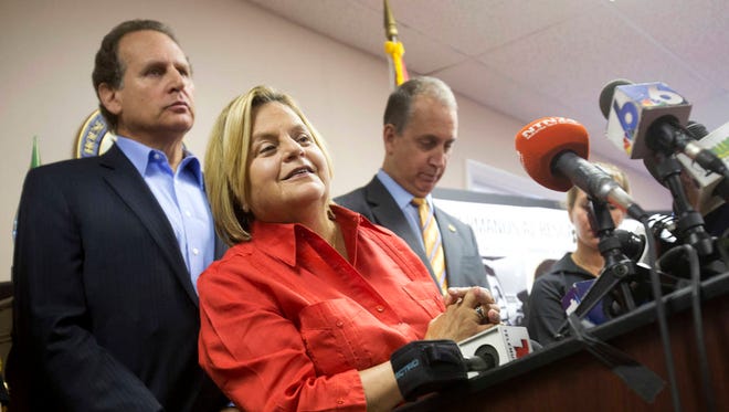 U.S. Rep. Ileana Ros-Lehtinen, R-Fla., center, listens to a question from the media as she is joined by U.S. Rep. Mario Diaz-Balart, R-Fla., right, and his brother, former Congressman Lincoln Diaz-Balart, during a news conference Aug. 12, 2015, in Miami. (Associated Press, file)