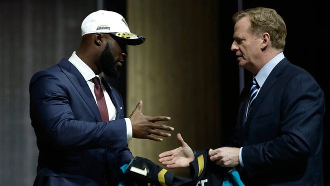 Leonard Fournette, left, greets NFL commissioner Roger Goodell after being selected by the Jaguars during the first round of the 2017 NFL football draft on Thursday in Philadelphia. (Associated Press)