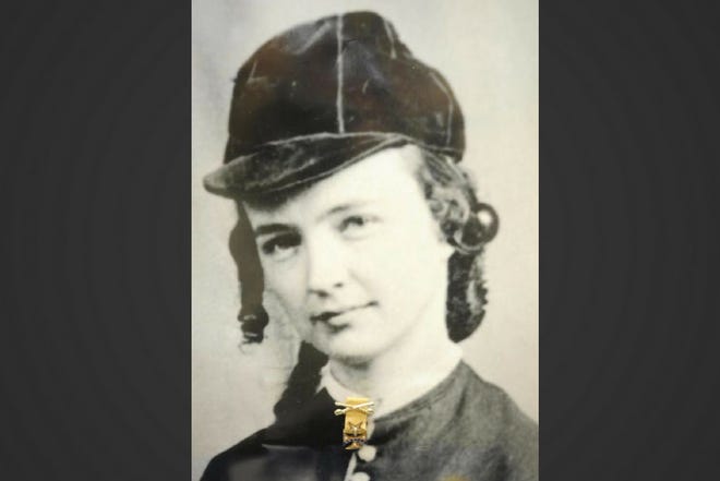 This 2012 Monroe News file photo shows an image of Elizabeth Bacon Custer at the Monroe County Historical Museum. Her Michigan 7th Cavalry Regimental badge was pinned to the image in honor of Custer Week that fall.